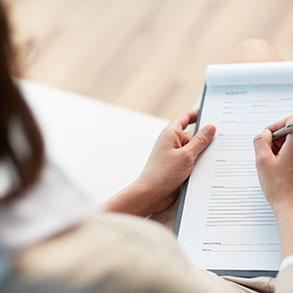 A woman filling out a worksheet